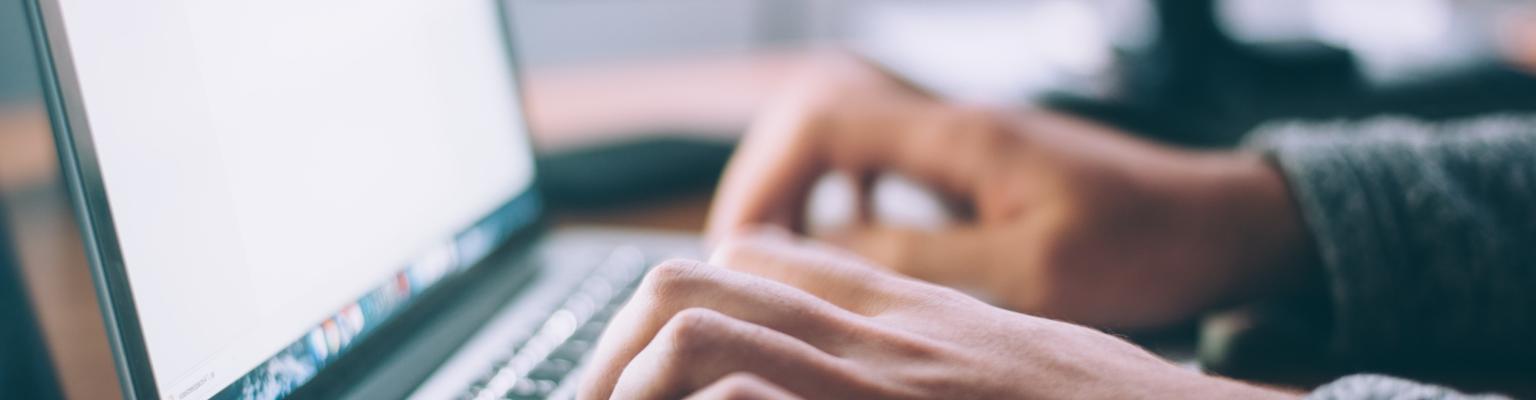 person typing on a laptop