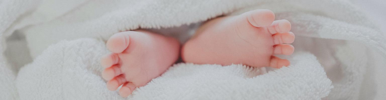 a babies feet wrapped in a cozy towel